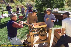 Michael Phillips and friends pressing cider from organic apples at Lost Nation Orchard at Heartsong Farm -- photo: Frank Siteman
