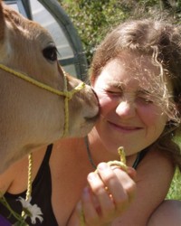 Our dear Molly (who apprenticed here in 2004) was especially gracious about receiving cow kisses. (photo by Michael Phillips)